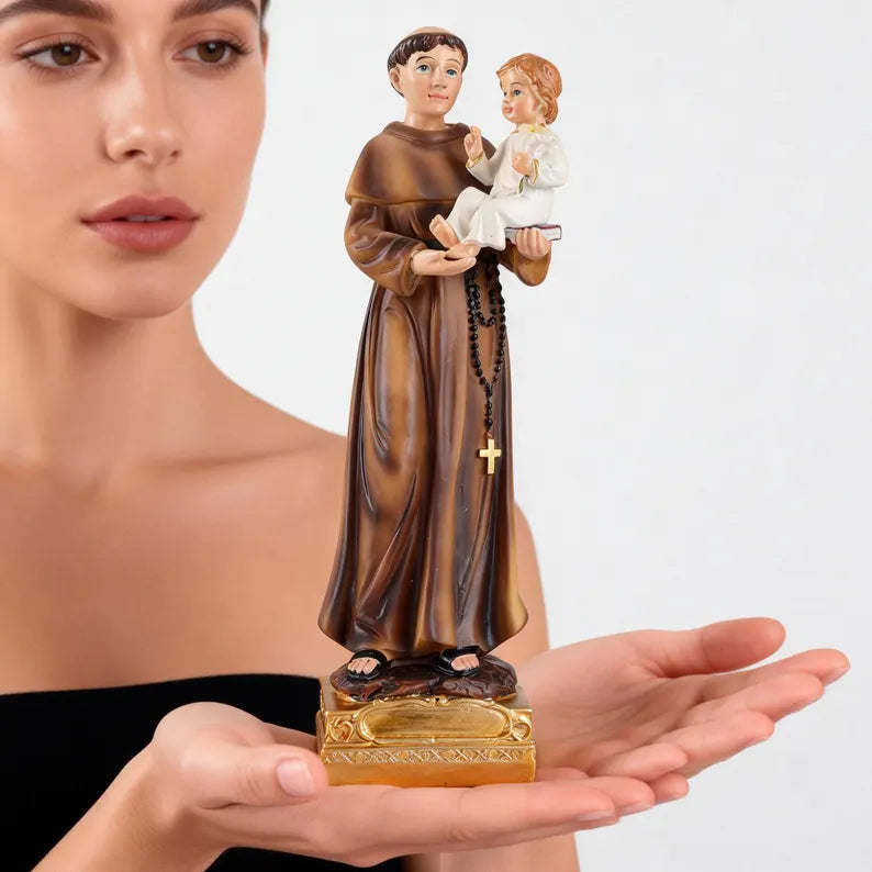 3-saint anthony statue with child jesus on model's hands